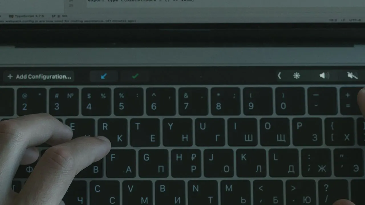 Close-up of hands on a laptop keyboard during a software session